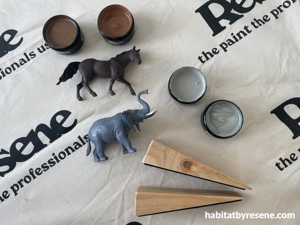 Doorstops, plastic animals and paint pots on a cloth