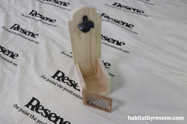 A wooden bottle opener project with a gate on the front