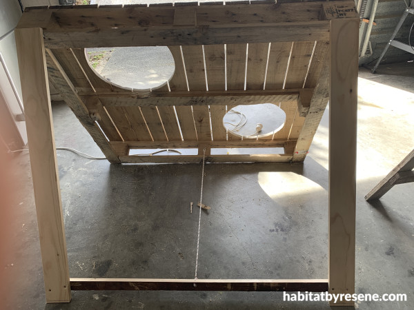 A pallet with holes and a stand