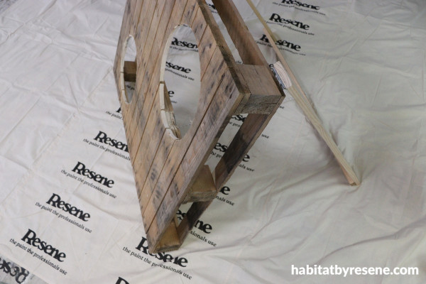 A pallet with holes and a stand