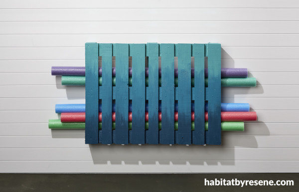 A painted pallet with pool noodles