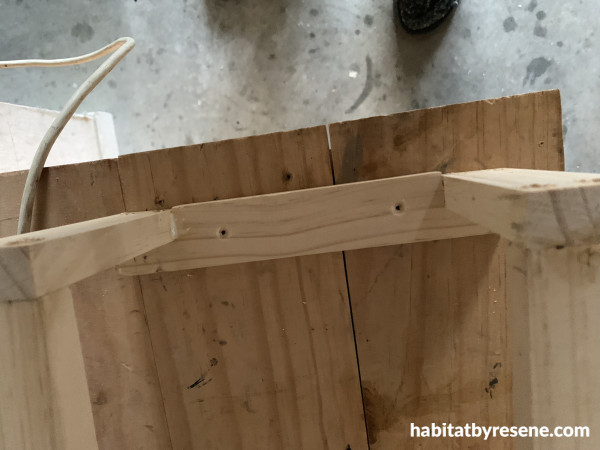 A piece of wood with screw holes to attach to a wall
