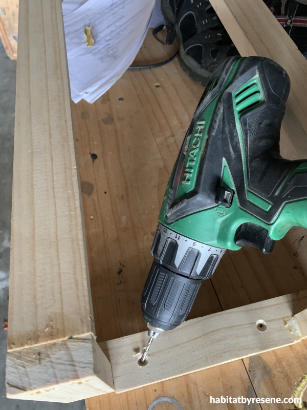 A drill making holes in wood