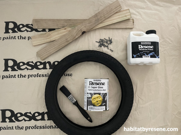 A tire and paint can on a cloth