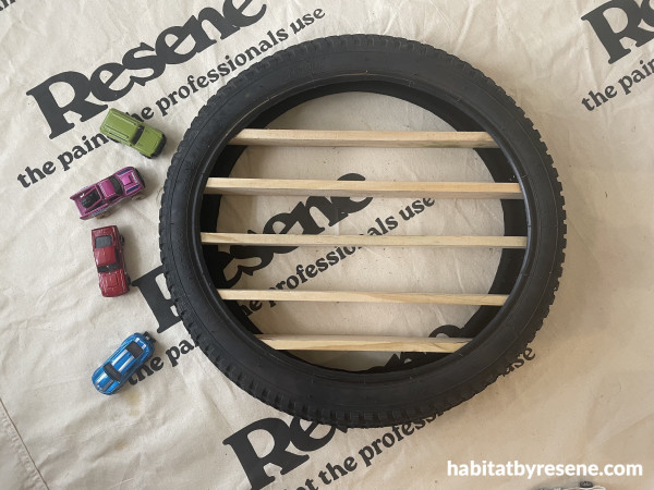 A tyre and toy cars