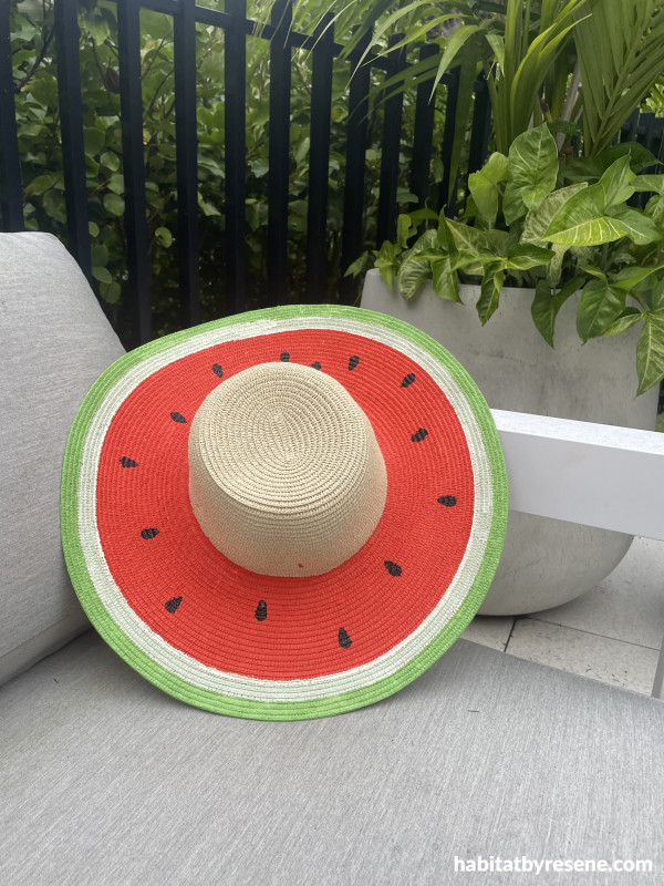 A hot on a chair with a watermelon pattern