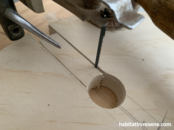 A saw cutting a piece of wood