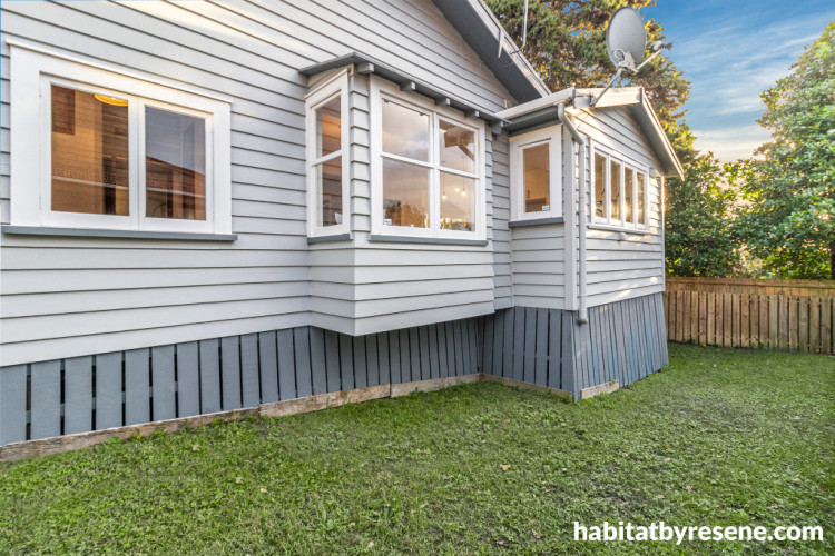 House exterior painted in Resene Half Silver Chalice with smoky blue frames in Resene Snapshot