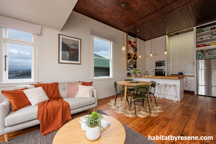 Kitchen and dining area with Resene Colorwood Dark Rimu ceiling walls and trims painted in Resene Milk White.
