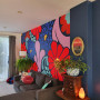 Floral mural featuring painted in red, purple, pink and blue colours