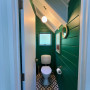 toilet is now modern and bright, painted in Resene Fun Green with Resene Quarter Rice Cake on doors and Resene Ceiling Paint White on the ceiling.&nbsp;