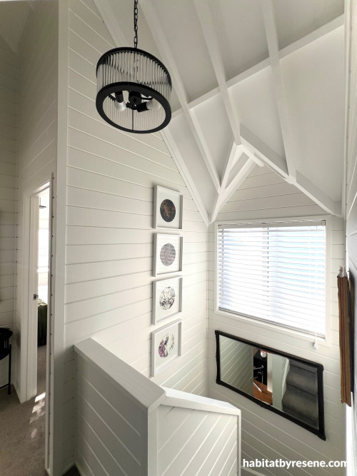 The staircase shines with its high-pitched ceiling in painted Resene Ceiling Paint White and warm new coat of Resene Rice Cake on the walls.