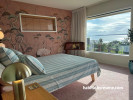 Bedroom featuring Resene wallpaper and painted in Resene Rainee and Resene Half Wheatfield