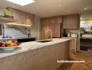 Kitchen with wood features and painted in Resene Wheatfield