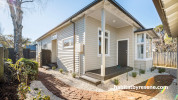 House exterior painted in Resene Half Grey Olive and Resene Black White