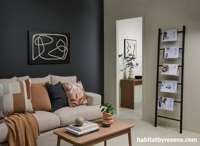 Living area with moody feature wall painted in Resene Nocturnal and side wall in Resene Quarter Akaroa