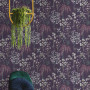 Wallpaper with violet tones creates moody meadow atmosphere in room