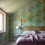 Wallpaper creates exiting outdoors atmosphere in bedroom