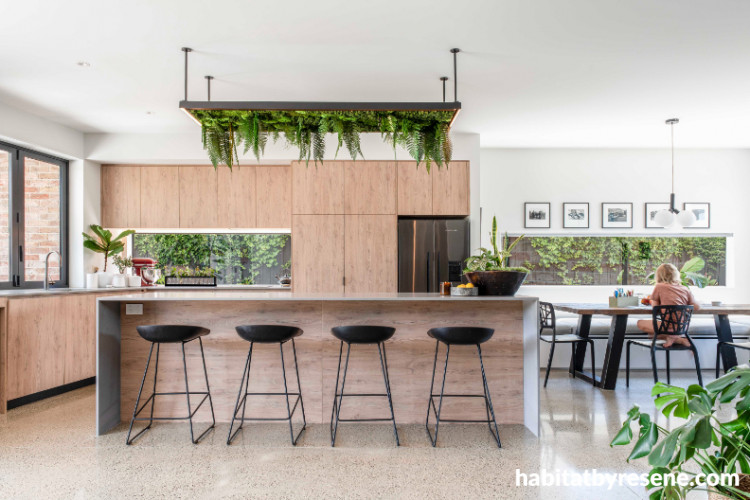 Kitchen in bright white tones balanced with natural wood paneling