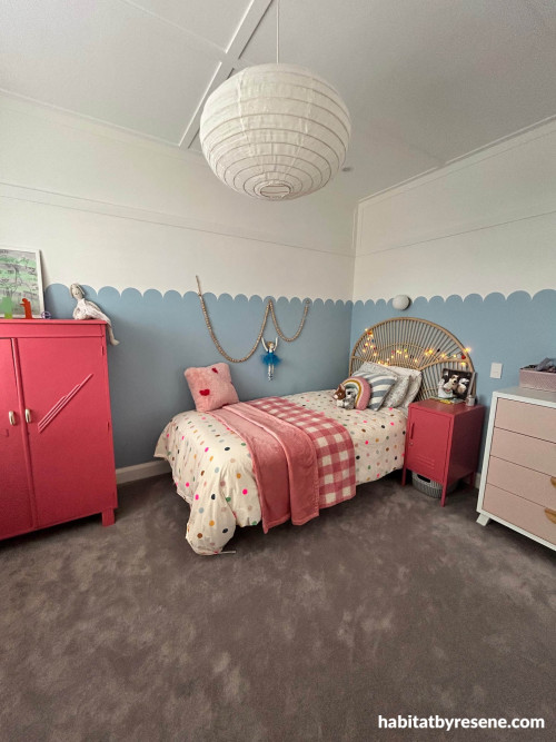 Bedroom painted in half blue and half white colours