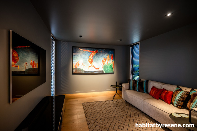 Media room drenched in moody and bold tones