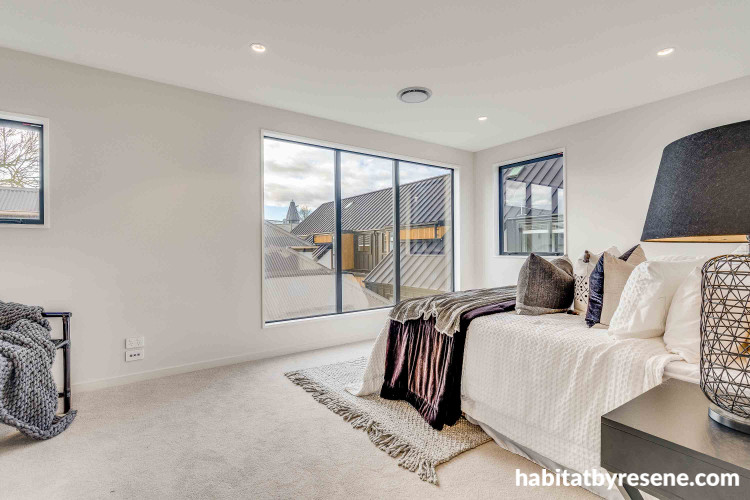White walls brighten master bedroom