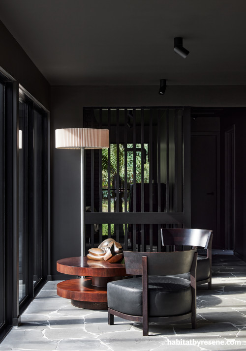 Bold, dark living area painted in Resene Ironsand and Resene Half Bokara Grey
