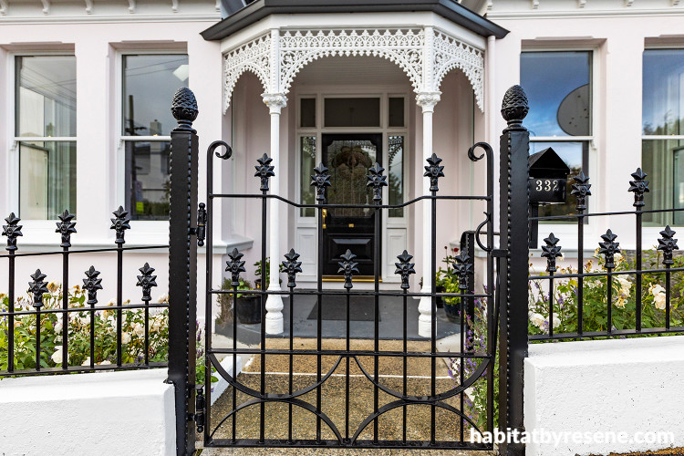 Villa exterior featuring pale pink Resene Sauvignon contrasted with detailing and fretwork in Resene Black and Resene Alabaster