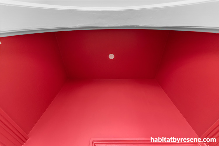 Feature wall and ceiling painted in vibrant Resene Pohutukawa