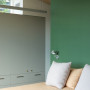 A bedroom with a green wall in Resene Ranger
