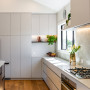 Kitchen cabinets painted in Resene AquaLAQ in Resene Truffle and ceiling in Resene Quarter Rice Cake