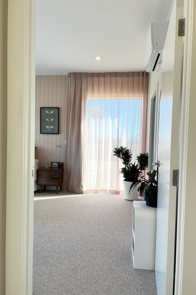 Warm neutrals and blush hues bring this Oratia home to life