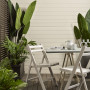 An outdoor dining set with plants