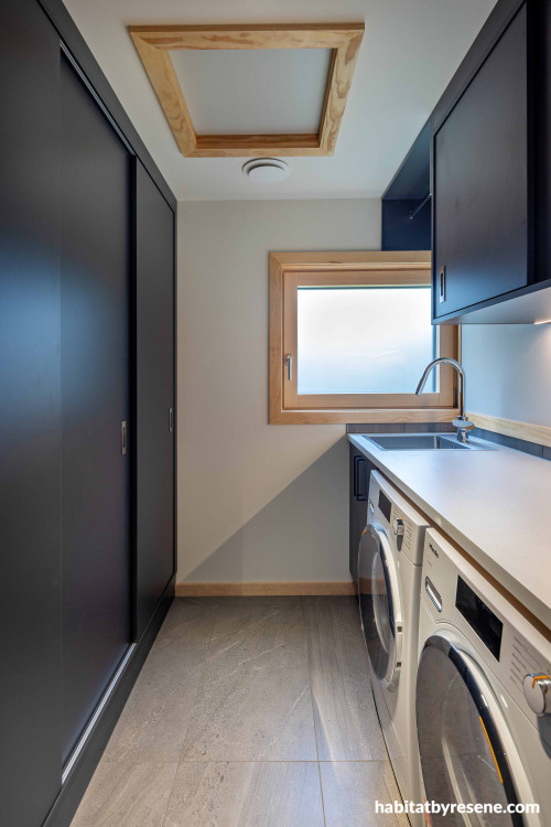 Laundry, dark laundry, laundry featuring contrasting walls and wooden trims