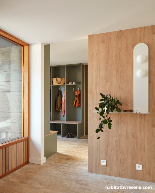Entryway with wooden shelves and walls painted in Resene Double Lemon Grass