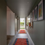 Hallway painted in refined green Resene Rivergum