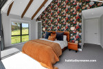 Master bedroom with feature wall featuring bold floral wallpaper