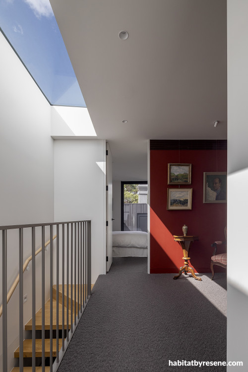 A hallway with a red wall
