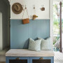 A blue entrance with a bench seat and cushions