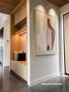 A white entrance with built in seat and artwok