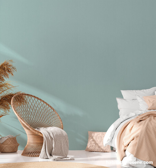 Tranquil bedroom with light green wallpaper