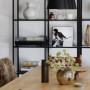 Black fittings contrast to white walls in dining room