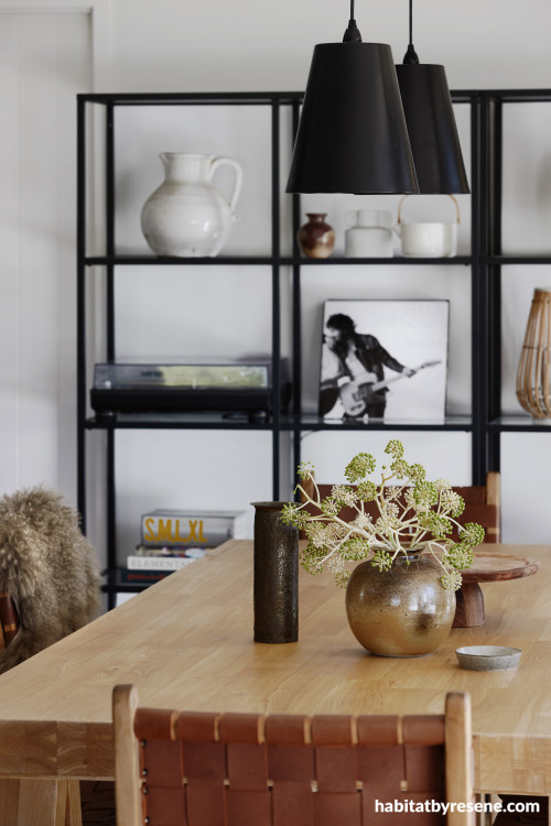 Black fittings contrast to white walls in dining room
