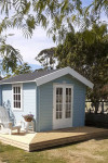Two colourful SheSheds decorated with Resene