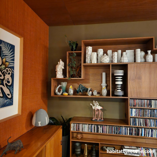 Living area with art, living area with display shelves, living area with art and ceramics
