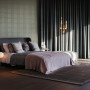 Bedroom featuring wallpaper with an elegant but subtle embossed pattern