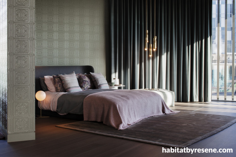 Bedroom featuring wallpaper with an elegant but subtle embossed pattern