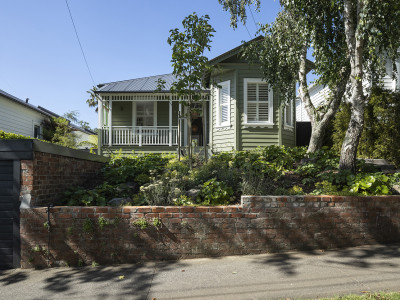 A serene villa adorned in timeless greens and whites