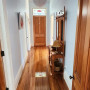 Hallway, hallway featuring neutral walls and wooden floors