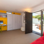living area, lounge, yellow feature wall, white and yellow, renovated villa, yellow paint
